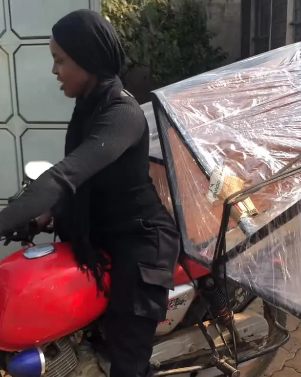 Rider loading a wrapped piece onto a motorbike